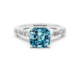 White gold Cushion Cut Blue Topaz Solitaire with Side Baguettes and Channel Set Band