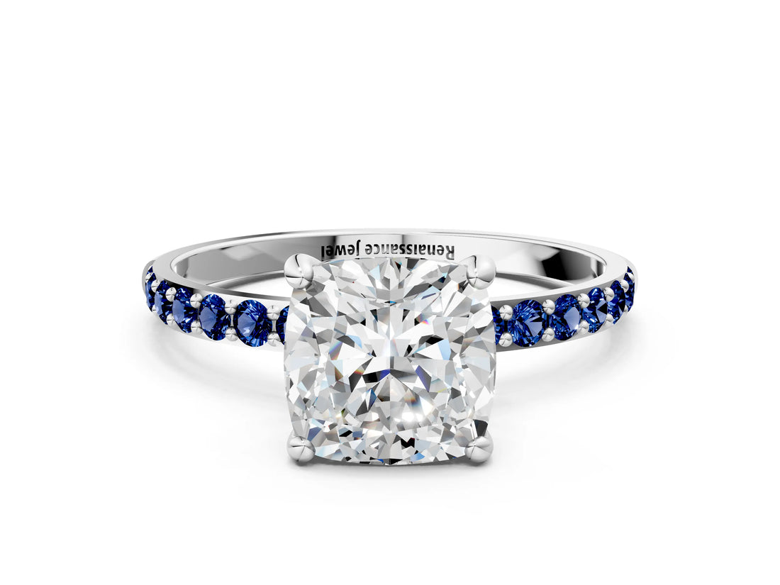 White gold Cushion Cut Diamond Solitaire Ring with Round with Blue Sapphire side stone Pavé Band and Prong Setting