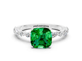 White gold Cushion Cut Emerald Solitaire with Side Stones on a Pavé Band and Four-Prong Setting