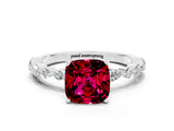 White gold Cushion Cut Garnet Solitaire with Side Stones on a Pavé Band and Four-Prong Setting