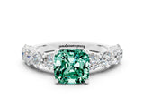 White gold Cushion Cut Green Sapphire Prong Setting with Side Stones on a Pave Band