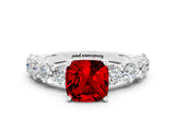 White gold Cushion Cut Ruby Prong Setting with Side Stones on a Pave Band