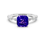 White gold Cushion Cut Tanzanite Solitaire with Side Stones on a Pavé Band and Four-Prong Setting