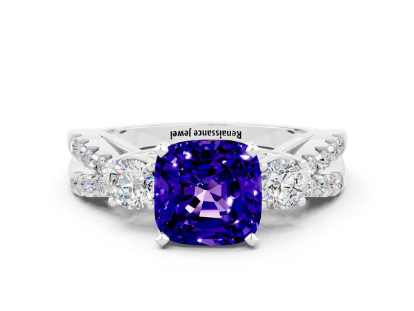 Platinum Cushion Cut Tanzanite Three-Stone Ring with Pavé Split Shank and Four-Prong Setting