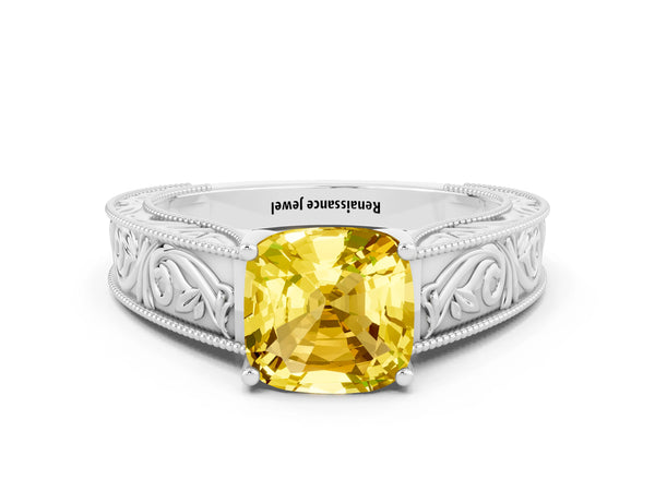 Platinum Cushion Cut Yellow Sapphire Solitaire Ring with Engraved Band and Four-Prong Setting