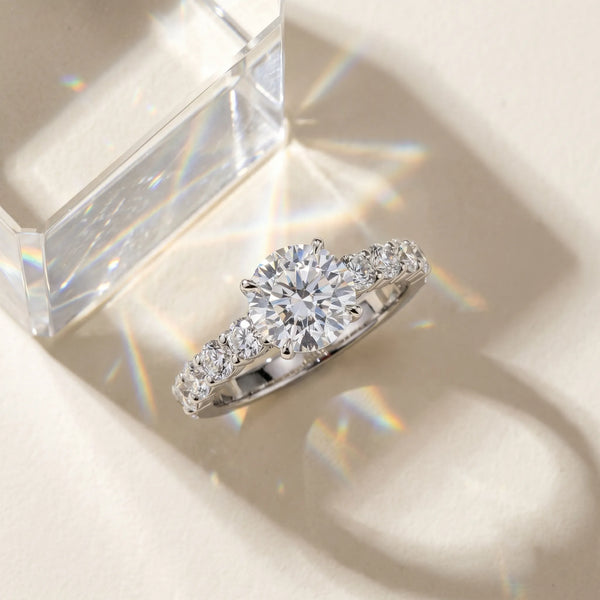 White gold Cushion Diamond Solitaire Ring with Shared Prong Round Side Stones