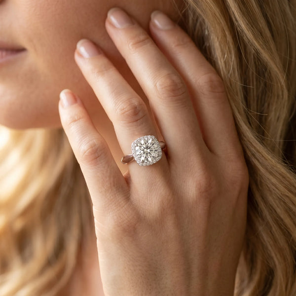 White gold Cushion Halo Round Brilliant Solitaire Ring with Tapered Band and Four-Prong Setting