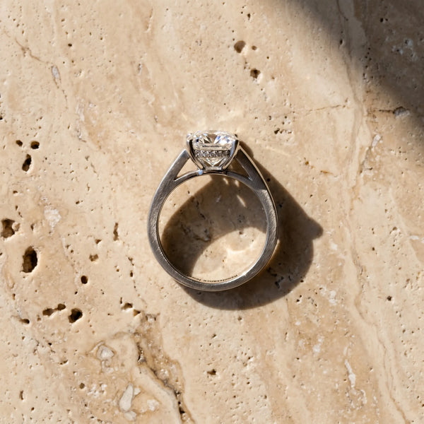 White gold Cushion Solitaire Engagement Ring with Four-Prong Setting and Tapered Band