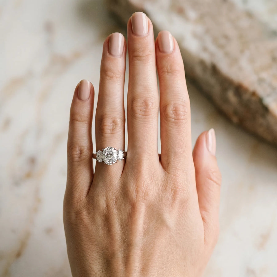White gold Cushion Three-Stone Diamond Ring with Prong Setting on a Classic Band