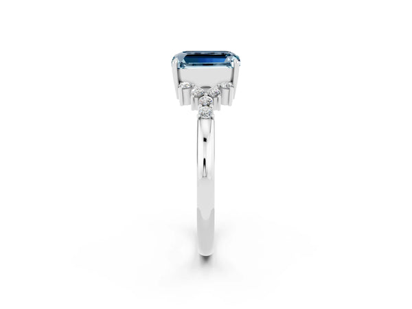 Platinum Emerald Cut Aquamarine Ring with Side Stones and Four-Prong Setting