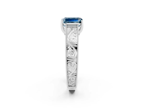 Platinum Emerald Cut Aquamarine Solitaire Ring with Engraved Band and Four-Prong Setting