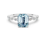 White gold Emerald Cut Aquamarine Solitaire with Side Stones on a Pavé Band and Four-Prong Setting