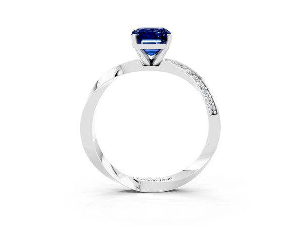 Platinum Emerald Cut Blue Sapphire Engagement Ring with Side Stone Accents and Four-Prong Setting