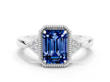 White gold Emerald Cut Blue Sapphire Halo Ring with Tapered Band and Four-Prong Setting