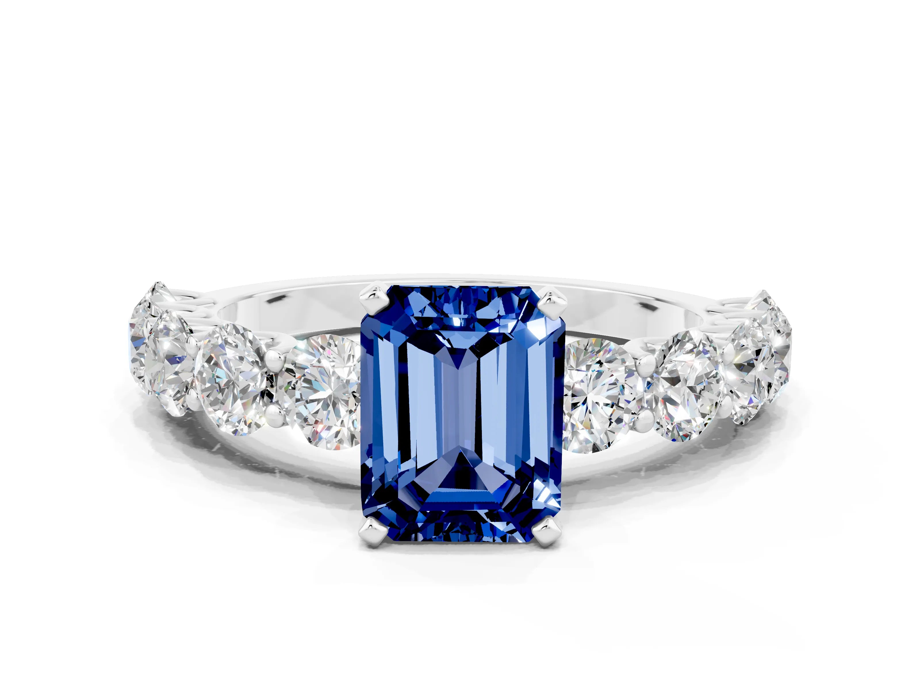White gold Emerald Cut Blue Sapphire Prong Setting with Side Stones on a Pave Band