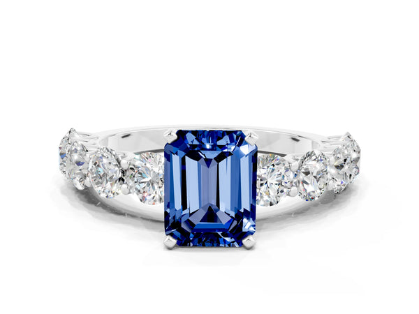 White gold Emerald Cut Blue Sapphire Prong Setting with Side Stones on a Pave Band