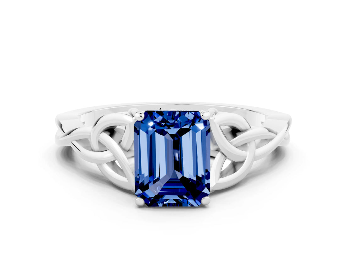 White gold Emerald Cut Blue Sapphire Solitaire Engagement Ring with Celtic Knot Band and Four-Prong Setting