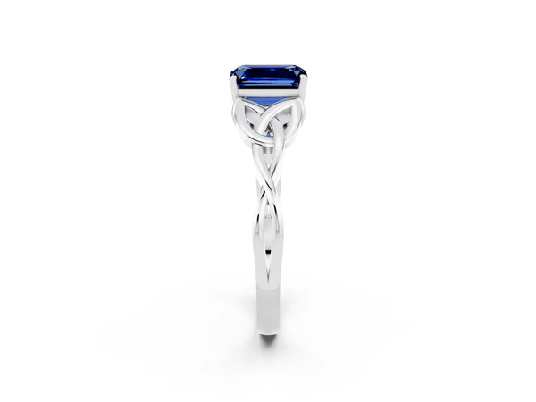 White gold Emerald Cut Blue Sapphire Solitaire Engagement Ring with Celtic Knot Band and Four-Prong Setting