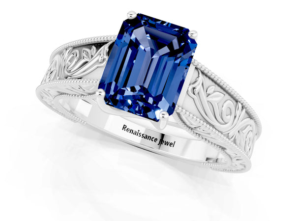 Platinum Emerald Cut Blue Sapphire Solitaire Ring with Engraved Band and Four-Prong Setting