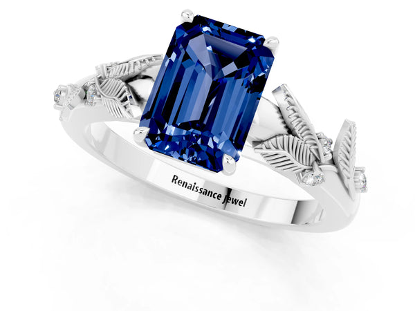 White gold Emerald Cut Blue Sapphire Solitaire Ring with Leaf Motif Band and Four-Prong Setting