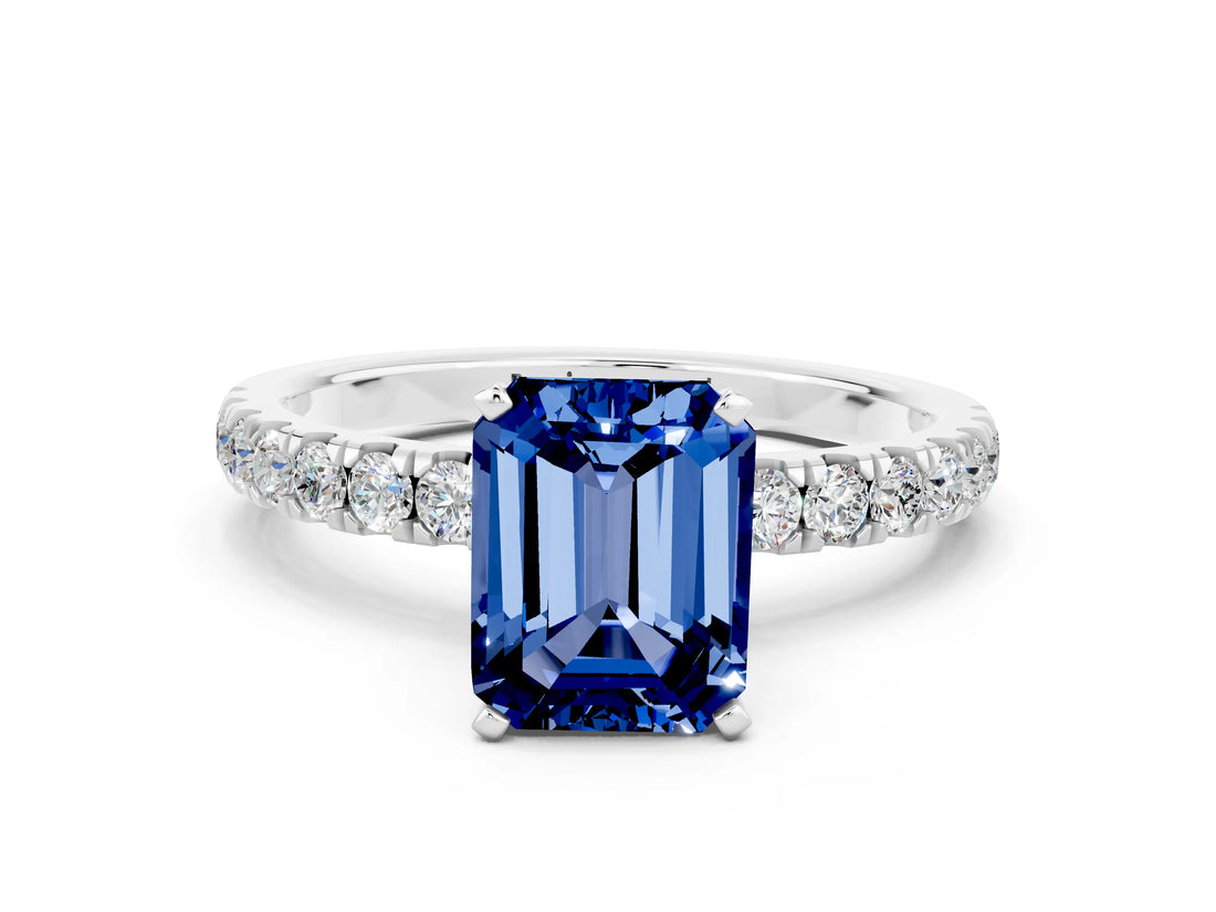 White gold Emerald Cut Blue Sapphire Solitaire Ring with Pavé Accents and Four-Prong Setting