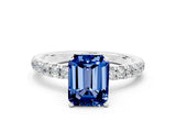 White gold Emerald Cut Blue Sapphire Solitaire Ring with Pavé Accents and Four-Prong Setting