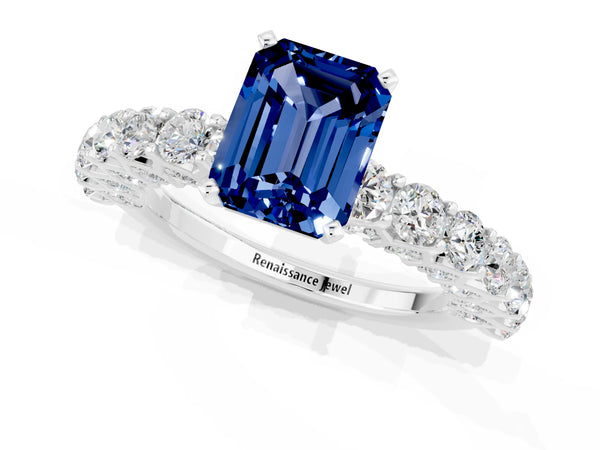 White gold Emerald Cut Blue Sapphire Solitaire Ring with Shared Prong Pavé Band and Four-Prong Setting