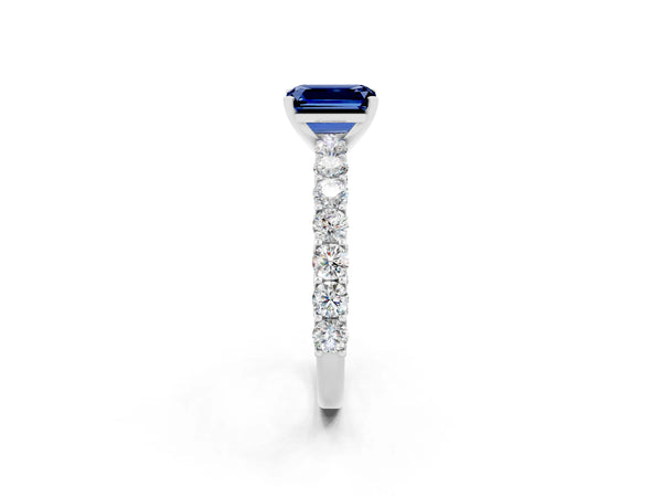 Silver Emerald Cut Blue Sapphire Solitaire Ring with Shared Prong Pavé Band and Four-Prong Setting