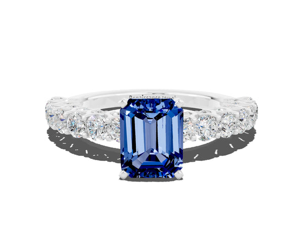 Silver Emerald Cut Blue Sapphire Solitaire Ring with Shared Prong Pavé Band and Four-Prong Setting