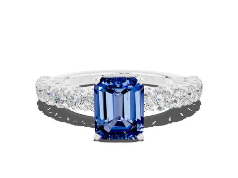 White gold Emerald Cut Blue Sapphire Solitaire Ring with Shared Prong Pavé Band and Four-Prong Setting