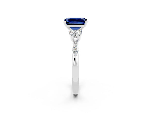 White gold Emerald Cut Blue Sapphire Solitaire Ring with Side Stones and Four-Prong Setting