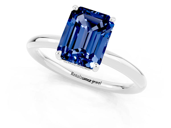 White gold Emerald Cut Blue Sapphire Solitaire Ring with Thin Band and Four-Prong Setting