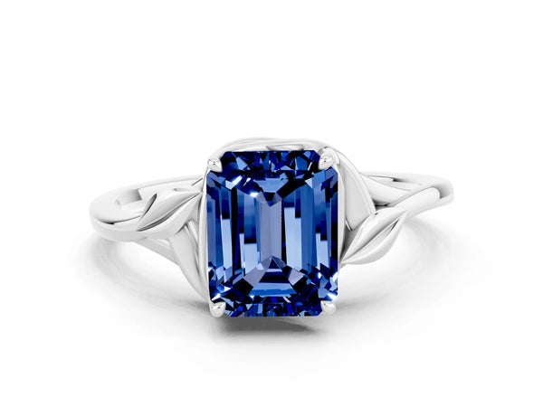 Platinum Emerald Cut Blue Sapphire Solitaire Ring with Twist Band and Four-Prong Setting