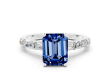 White gold Emerald Cut Blue Sapphire Solitaire with Side Baguettes and Channel Set Band