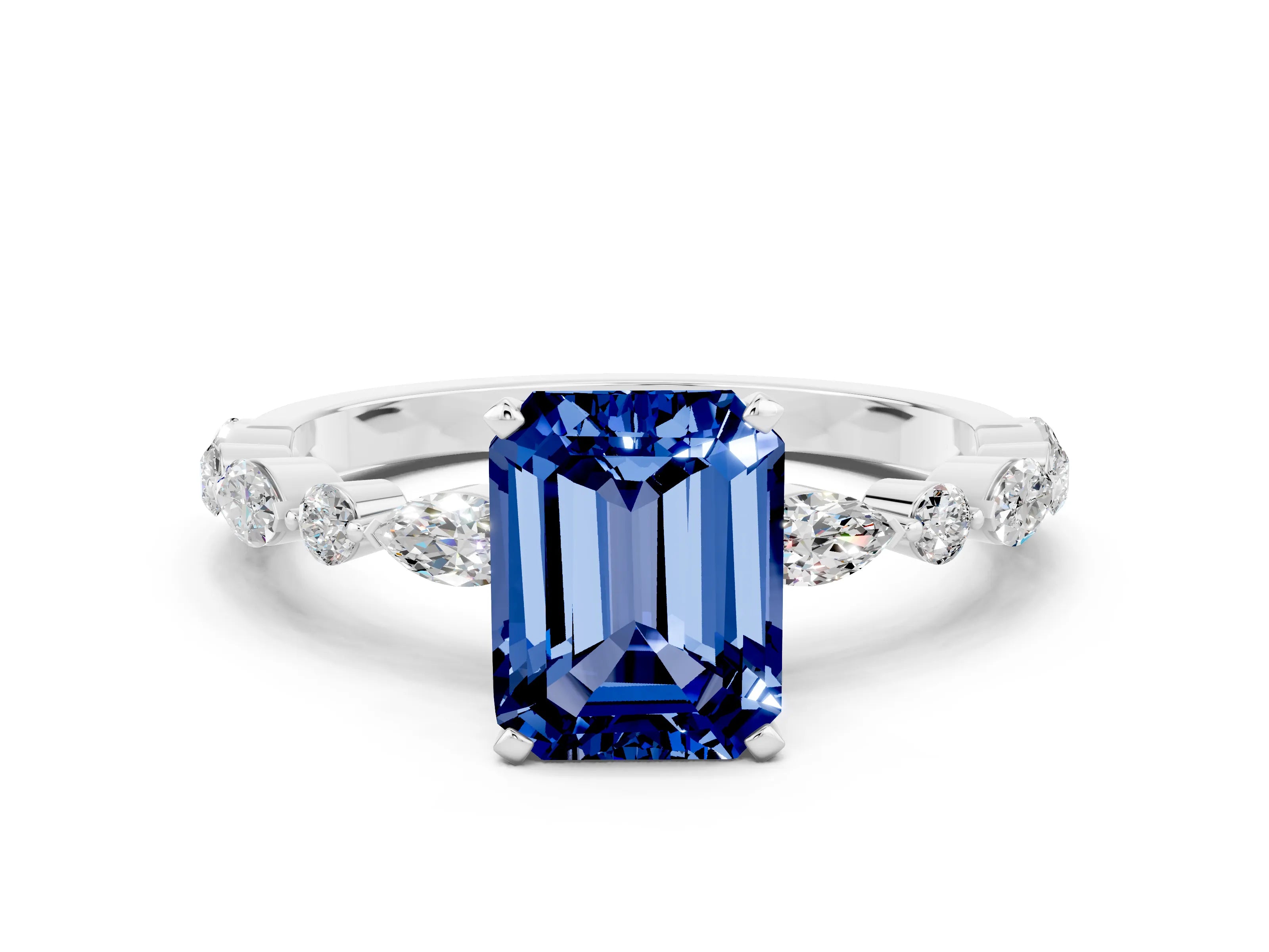 White gold Emerald Cut Blue Sapphire Solitaire with Side Stones on a Pavé Band and Four-Prong Setting