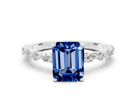 White gold Emerald Cut Blue Sapphire Solitaire with Side Stones on a Pavé Band and Four-Prong Setting