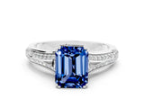 White gold Emerald Cut Blue Sapphire Split Shank Engagement Ring with Pavé Band