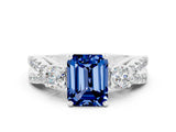 White gold Emerald Cut Blue Sapphire Three-Stone Ring with Pavé Split Shank and Four-Prong Setting