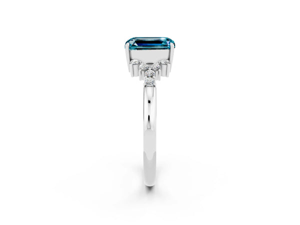 White gold Emerald Cut Blue Topaz Ring with Side Stones and Four-Prong Setting