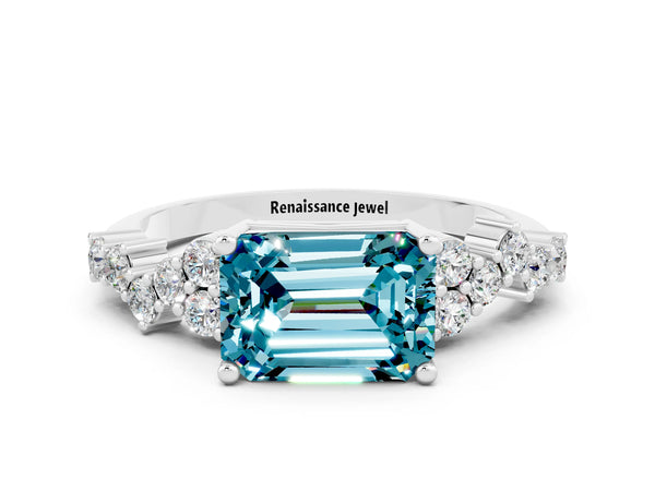 Platinum Emerald Cut Blue Topaz Scattered Round Accent Ring with Prong Setting