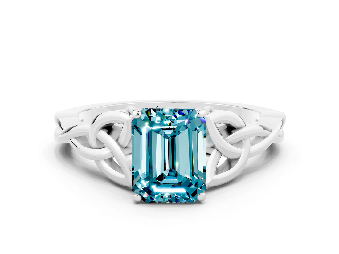 White gold Emerald Cut Blue Topaz Solitaire Engagement Ring with Celtic Knot Band and Four-Prong Setting