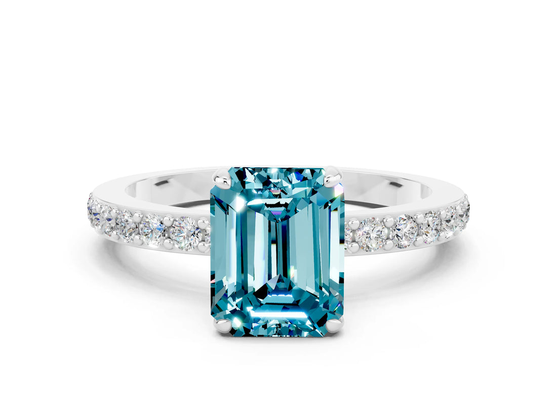 White gold Emerald Cut Blue Topaz Solitaire Engagement Ring with Pavé Band and Four-Prong Setting