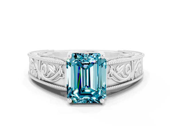 Platinum Emerald Cut Blue Topaz Solitaire Ring with Engraved Band and Four-Prong Setting