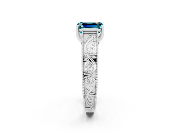 Silver Emerald Cut Blue Topaz Solitaire Ring with Engraved Band and Four-Prong Setting