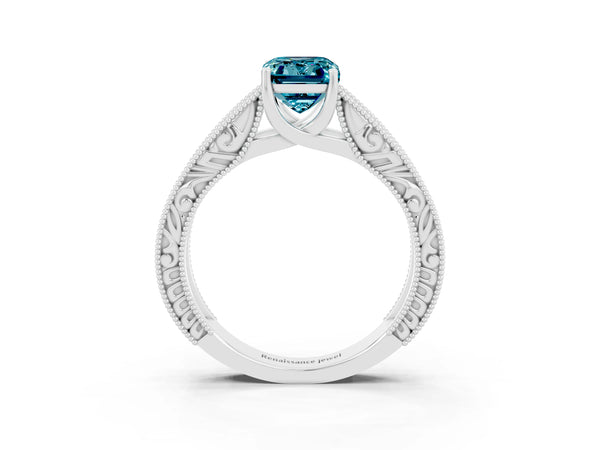 Silver Emerald Cut Blue Topaz Solitaire Ring with Engraved Band and Four-Prong Setting