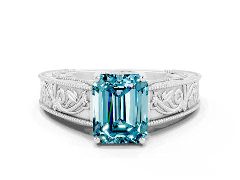 White gold Emerald Cut Blue Topaz Solitaire Ring with Engraved Band and Four-Prong Setting