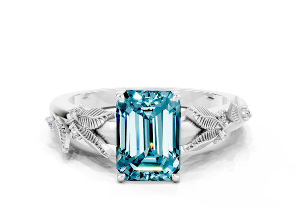 Platinum Emerald Cut Blue Topaz Solitaire Ring with Leaf Motif Band and Four-Prong Setting