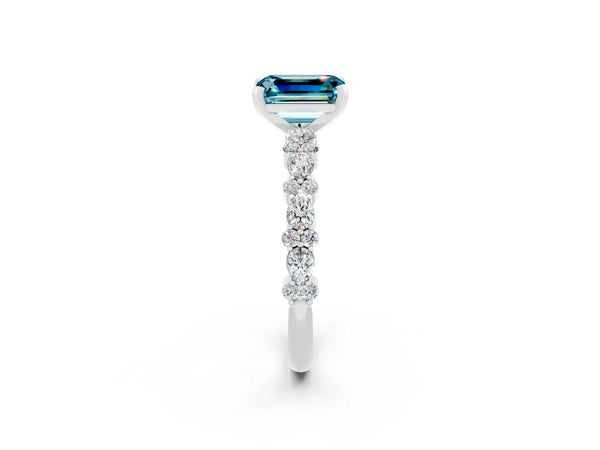 White gold Emerald Cut Blue Topaz Side Stone Solitaire Ring with Round  and Four-Prong Setting