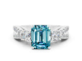White gold Emerald Cut Blue Topaz Three-Stone Ring with Pavé Split Shank and Four-Prong Setting