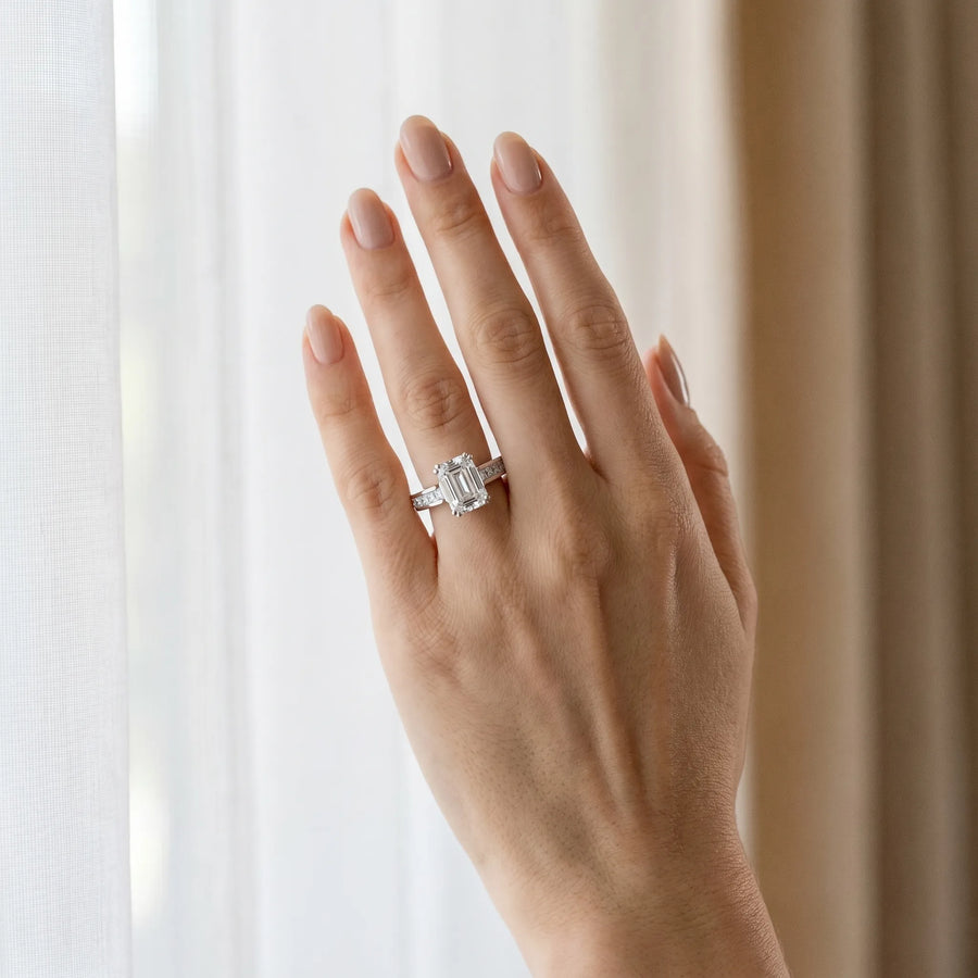 White gold Emerald Cut Channel Set Solitaire Engagement Ring with Prong Setting